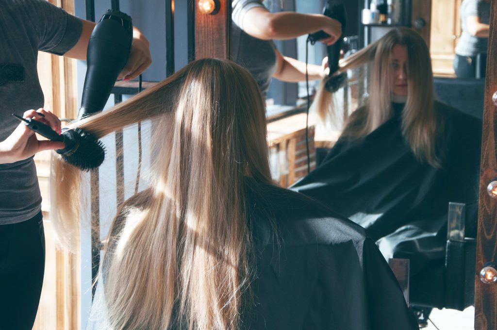 Woman blowdrying long hair